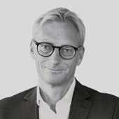 A person wearing glasses and a suit

AI-generated content may be incorrect.