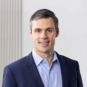 A person in a suit

AI-generated content may be incorrect.