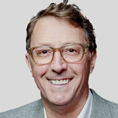 A person wearing glasses and a grey suit

AI-generated content may be incorrect.
