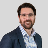 A person wearing glasses and a suit

AI-generated content may be incorrect.