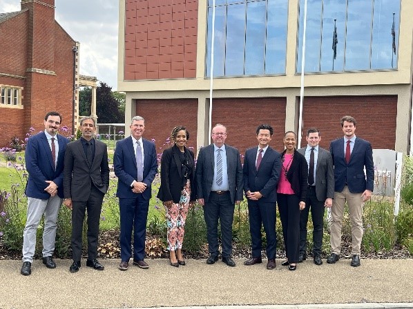 A group of people standing in front of a buildingDescription automatically generated